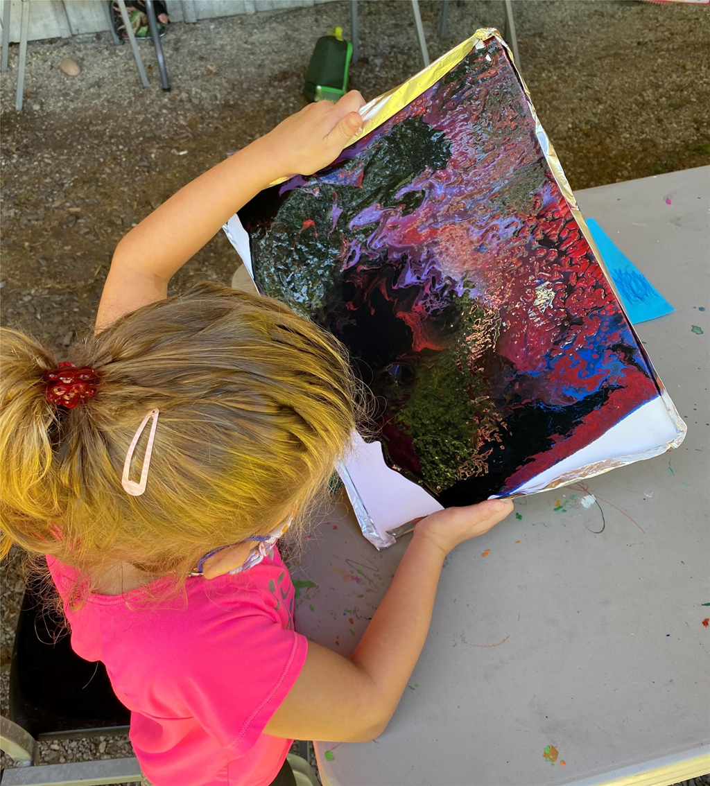 child with a colorful painting